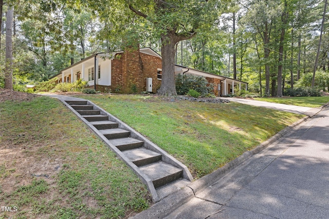 700 Tinkerbell Rd, Chapel Hill, NC 27517 - mid-century inspired home with a chimney, a front lawn, brick siding, and driveway