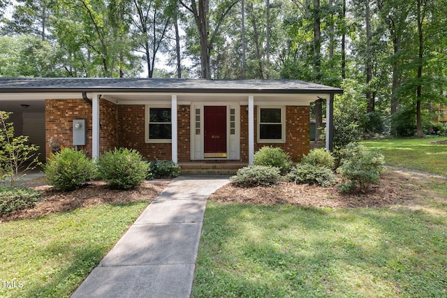 700 Tinkerbell Rd, Chapel Hill, NC 27517 - single story home with brick siding, covered porch, and a front yard