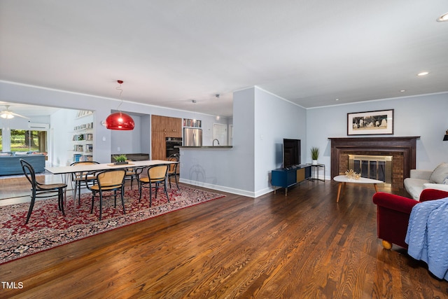 700 Tinkerbell Rd, Chapel Hill, NC 27517 - dining area featuring a glass covered fireplace, dark wood finished floors, a ceiling fan, recessed lighting, and ornamental molding