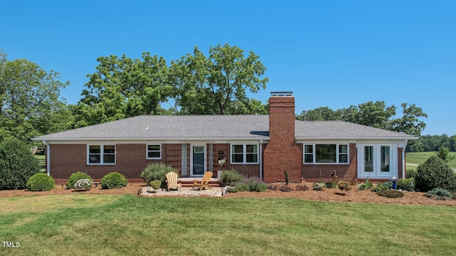 10781 US-158, Reidsville, NC 27320 - view of front facade featuring brick siding, a front yard, and a chimney