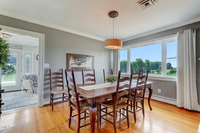 10781 US-158, Reidsville, NC 27320 - dining room featuring a baseboard radiator, healthy amount of natural light, light wood-style floors, and crown molding