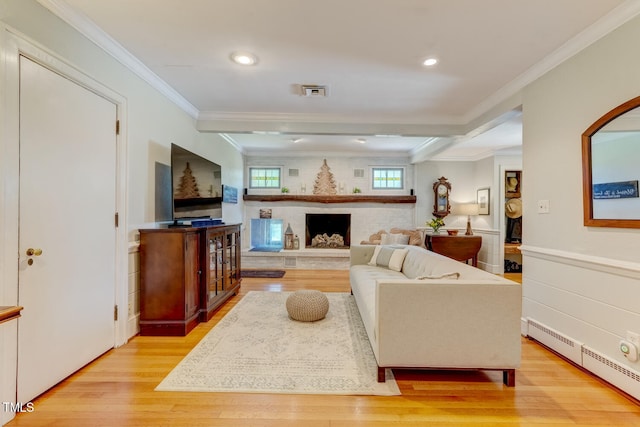 10781 US-158, Reidsville, NC 27320 - living room with baseboard heating, light wood-style floors, ornamental molding, a brick fireplace, and recessed lighting
