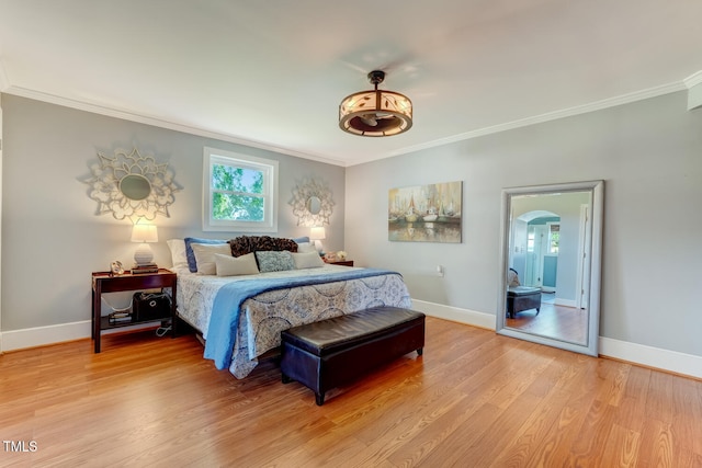 10781 US-158, Reidsville, NC 27320 - bedroom with crown molding, light wood-style floors, and arched walkways