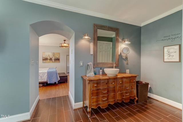 10781 US-158, Reidsville, NC 27320 - bathroom featuring wood finish floors, vanity, crown molding, and connected bathroom