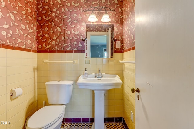 10781 US-158, Reidsville, NC 27320 - bathroom with wallpapered walls, a wainscoted wall, and tile walls