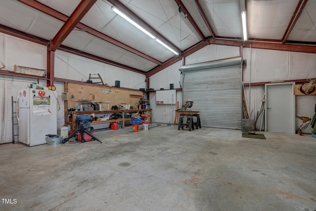 10781 US-158, Reidsville, NC 27320 - garage featuring freestanding refrigerator and a workshop area