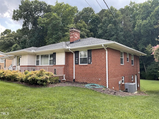 5924 Woodcrest Dr, Raleigh, NC 27603 - view of front of home with brick siding, a front lawn, a chimney, and a porch