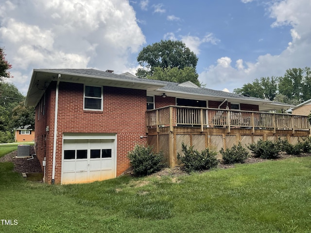 5924 Woodcrest Dr, Raleigh, NC 27603 - back of house with a garage, a wooden deck, brick siding, and a lawn