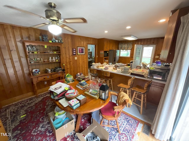 5924 Woodcrest Dr, Raleigh, NC 27603 - dining space with wood walls, ceiling fan, and recessed lighting