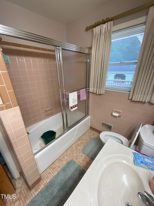 5924 Woodcrest Dr, Raleigh, NC 27603 - bathroom with shower / bath combination with glass door and tile patterned flooring