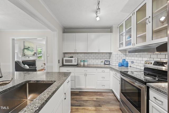 7 Meadowbrook Ave, Durham, NC 27712 - kitchen with stainless steel range with electric stovetop, white microwave, a textured ceiling, backsplash, and dark wood-style floors