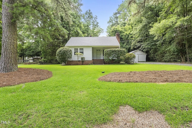 7 Meadowbrook Ave, Durham, NC 27712 - view of front of house with a front yard, a chimney, and a storage shed