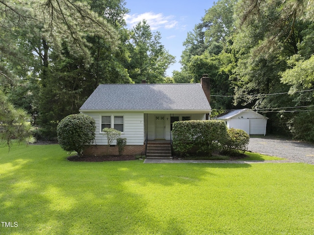 7 Meadowbrook Ave, Durham, NC 27712 - view of front of house with a front yard, a chimney, an outbuilding, covered porch, and a shingled roof