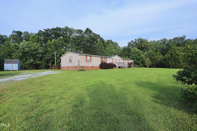 69 Laurel Meadows Ct, Burlington, NC 27217 - view of grassy yard with a storage unit and dirt driveway