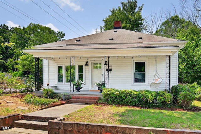1001 Lancaster St, Durham, NC 27701 - view of front of home featuring a porch, a chimney, and roof with shingles