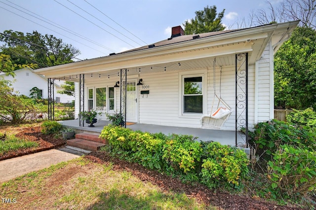 1001 Lancaster St, Durham, NC 27701 - view of front facade featuring covered porch and a chimney