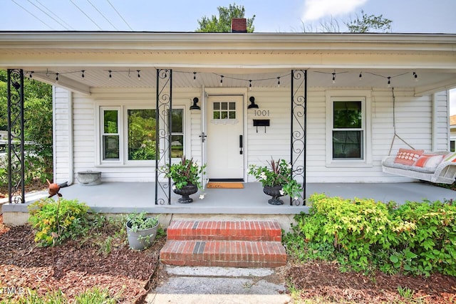 1001 Lancaster St, Durham, NC 27701 - doorway to property with covered porch and a chimney