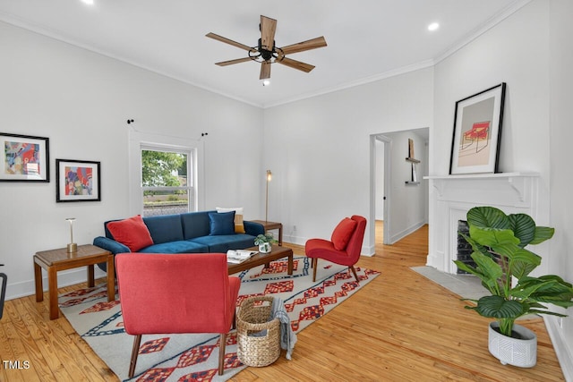1001 Lancaster St, Durham, NC 27701 - living area featuring light wood-style floors, ornamental molding, a ceiling fan, a fireplace with flush hearth, and recessed lighting
