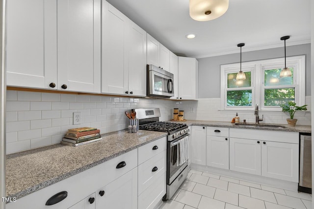 1001 Lancaster St, Durham, NC 27701 - kitchen with stainless steel appliances, crown molding, white cabinetry, backsplash, and light stone counters