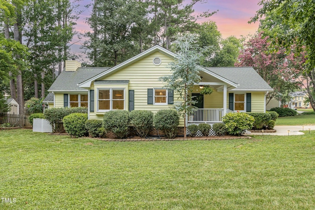 6025 Tarnhour Ct, Raleigh, NC 27612 - view of front of property with a yard, covered porch, a chimney, and a shingled roof