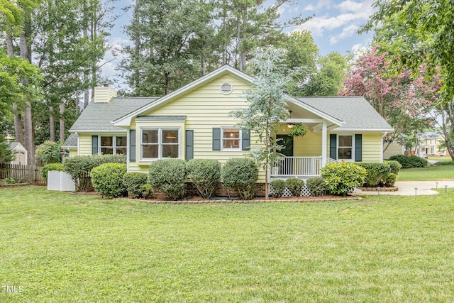 6025 Tarnhour Ct, Raleigh, NC 27612 - view of front of house with a front lawn, a chimney, a porch, and a shingled roof