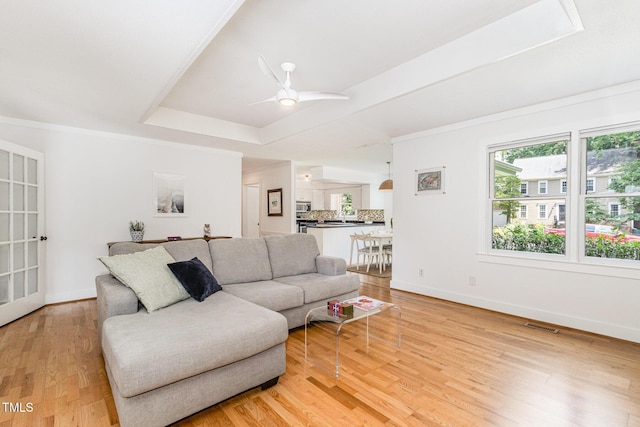 6025 Tarnhour Ct, Raleigh, NC 27612 - living area with light wood-style floors, ceiling fan, and a tray ceiling