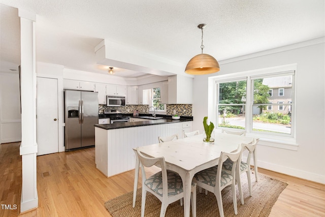 6025 Tarnhour Ct, Raleigh, NC 27612 - dining space with light wood-type flooring and baseboards