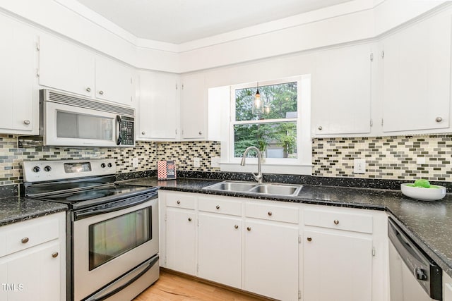 6025 Tarnhour Ct, Raleigh, NC 27612 - kitchen with stainless steel appliances, tasteful backsplash, white cabinets, light wood-type flooring, and dark stone countertops