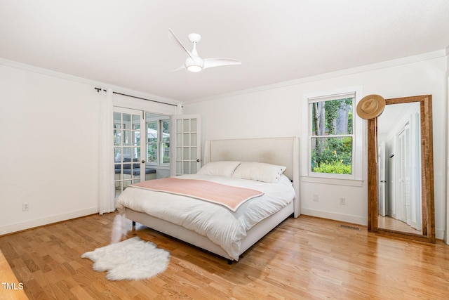 6025 Tarnhour Ct, Raleigh, NC 27612 - bedroom featuring light wood-type flooring, ornamental molding, a ceiling fan, and french doors