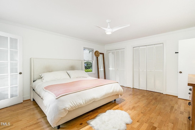 6025 Tarnhour Ct, Raleigh, NC 27612 - bedroom with two closets, light wood-style floors, ceiling fan, and crown molding