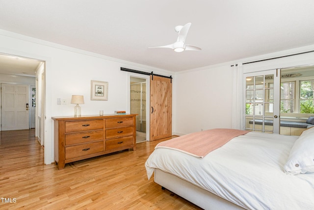 6025 Tarnhour Ct, Raleigh, NC 27612 - bedroom with light wood-type flooring, a barn door, a ceiling fan, and access to exterior
