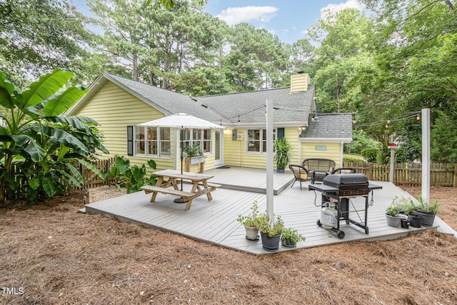 6025 Tarnhour Ct, Raleigh, NC 27612 - back of property featuring a wooden deck, a shingled roof, and a chimney