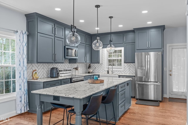 511 Scotts Ridge Trl, Apex, NC 27502 - kitchen with stainless steel appliances, decorative backsplash, light stone countertops, plenty of natural light, and recessed lighting