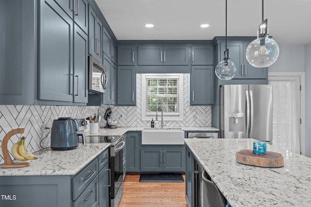 511 Scotts Ridge Trl, Apex, NC 27502 - kitchen featuring stainless steel appliances, light stone counters, pendant lighting, tasteful backsplash, and recessed lighting