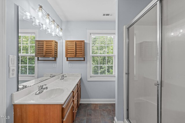 511 Scotts Ridge Trl, Apex, NC 27502 - bathroom featuring double vanity, plenty of natural light, a stall shower, and stone finish floors