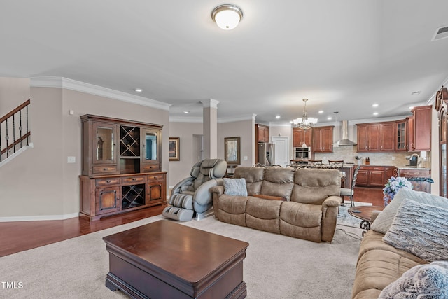 1950 Firenza Dr, Apex, NC 27502 - living area featuring decorative columns, recessed lighting, a chandelier, carpet, and crown molding