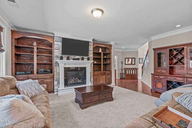 1950 Firenza Dr, Apex, NC 27502 - carpeted living area with crown molding, a large fireplace, and recessed lighting
