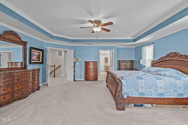 1950 Firenza Dr, Apex, NC 27502 - carpeted bedroom with crown molding, a tray ceiling, a ceiling fan, and ensuite bathroom