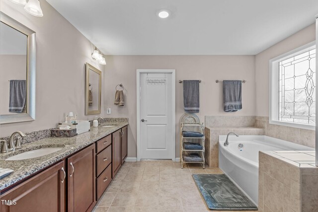 1950 Firenza Dr, Apex, NC 27502 - bathroom featuring a bath, double vanity, and tile patterned flooring