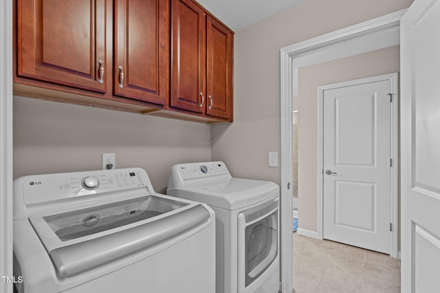 1950 Firenza Dr, Apex, NC 27502 - washroom with washer and clothes dryer, cabinet space, and light tile patterned floors
