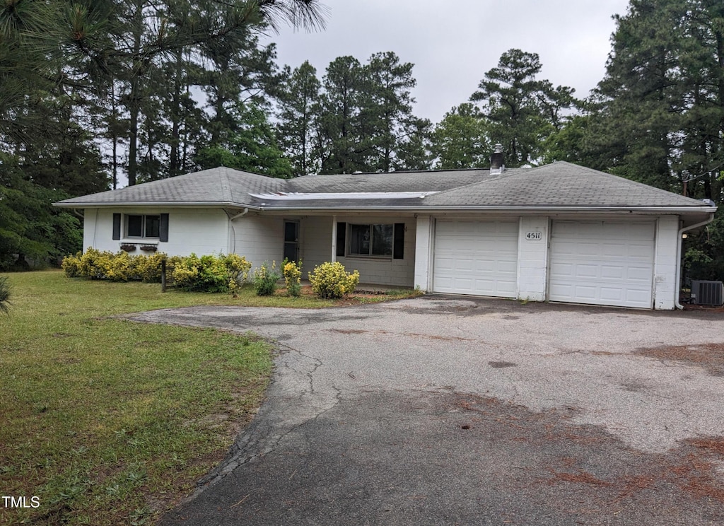 4511 Hopson Rd, Morrisville, NC 27560 - ranch-style home with driveway, a garage, and a front lawn
