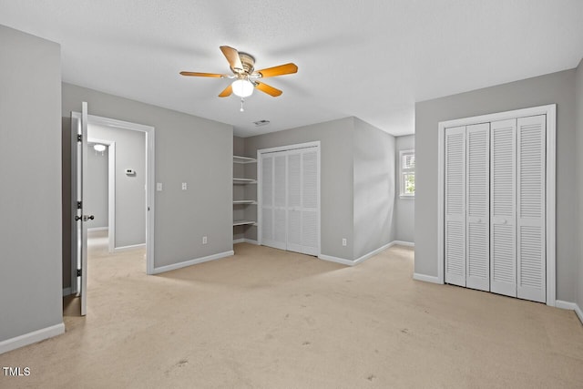 3104 Braywood Ct, Apex, NC 27539 - unfurnished bedroom featuring multiple closets, light colored carpet, and ceiling fan