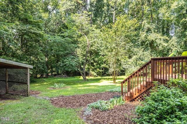 3104 Braywood Ct, Apex, NC 27539 - view of green lawn with stairs, a wooden deck, and a wooded view