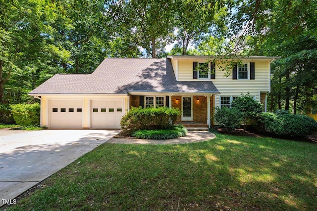 2330 Thunder Rd, Durham, NC 27712 - traditional home featuring a garage, driveway, a front lawn, and brick siding