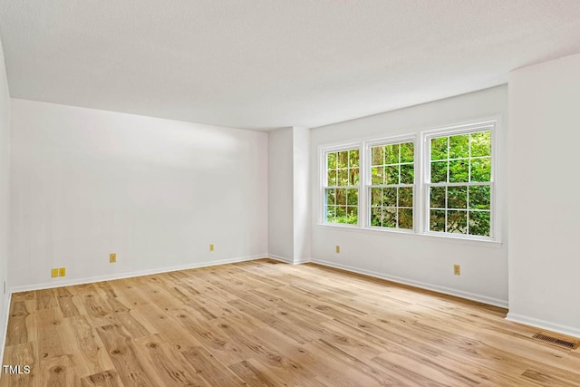 2330 Thunder Rd, Durham, NC 27712 - spare room featuring wood finished floors and a textured ceiling