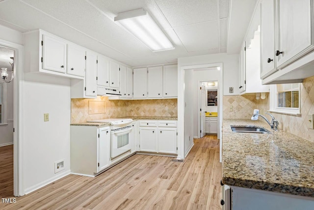 2330 Thunder Rd, Durham, NC 27712 - kitchen with under cabinet range hood, electric stove, light wood-style flooring, and white cabinets