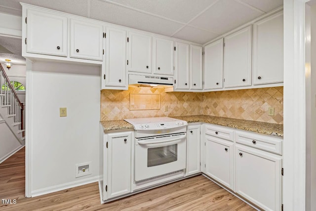 2330 Thunder Rd, Durham, NC 27712 - kitchen with white electric range, under cabinet range hood, light wood finished floors, white cabinets, and light stone counters