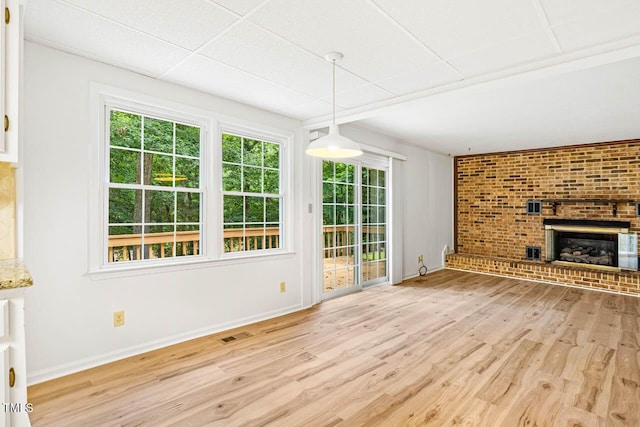 2330 Thunder Rd, Durham, NC 27712 - unfurnished living room with wood finished floors, plenty of natural light, and a brick fireplace
