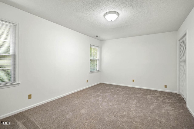 2330 Thunder Rd, Durham, NC 27712 - unfurnished bedroom featuring carpet, a textured ceiling, and a closet