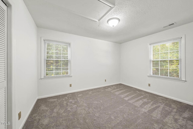 2330 Thunder Rd, Durham, NC 27712 - carpeted empty room featuring attic access and a textured ceiling